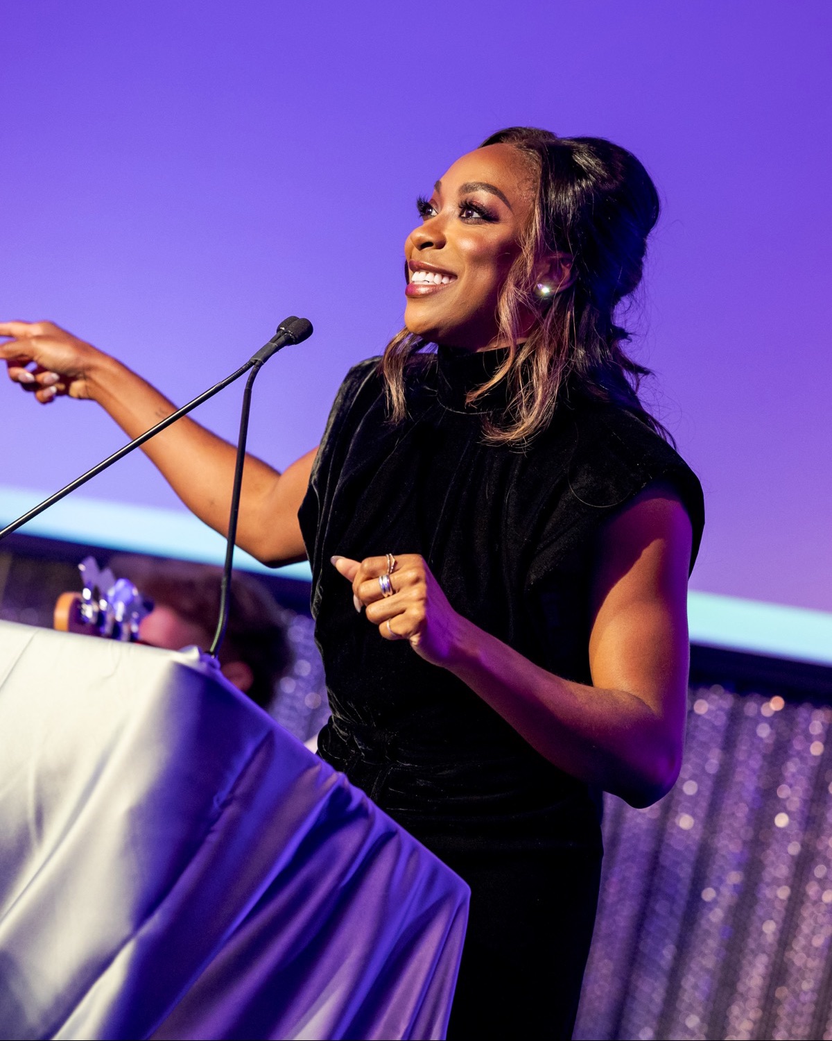 A speaker points out to the crowd from the podium at the BAC Artivism Gala