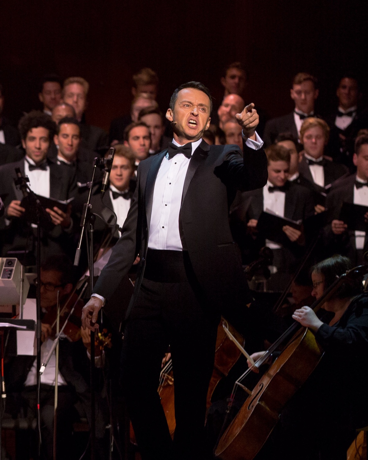 Andrew Lippa performs in front of the orchestra and chorus in I Am Harvey Milk