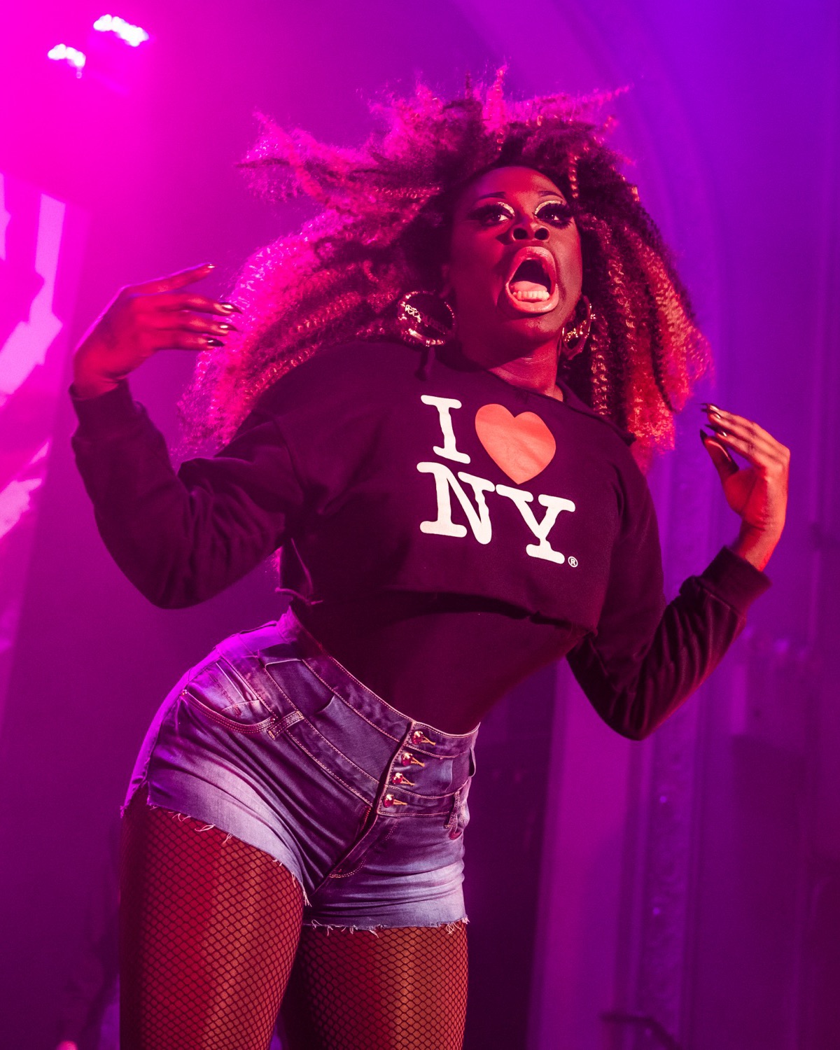Bob the Drag Queen performing under pink light in NUBIA