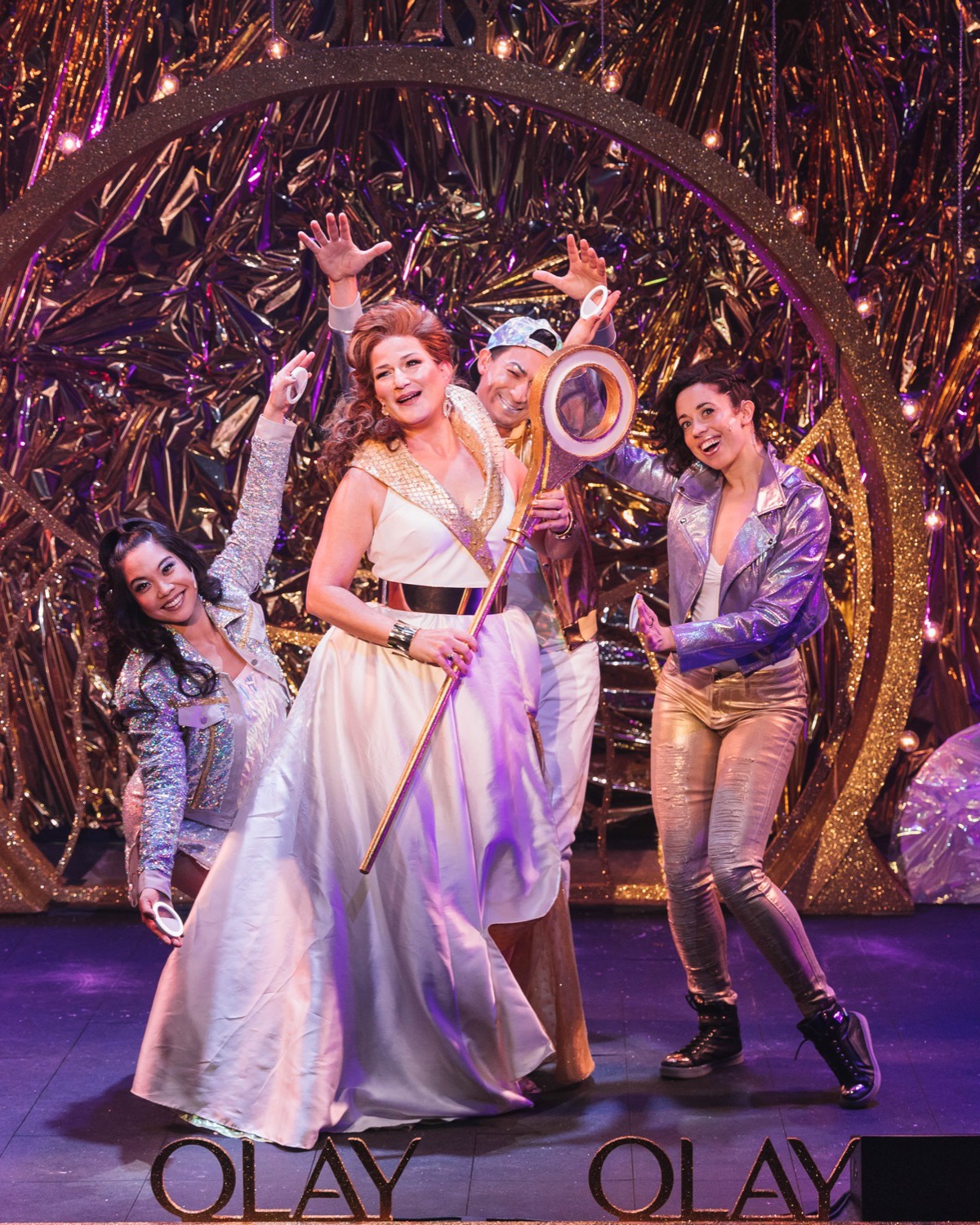 Performers on a gold, glittering stage for Olay’s musical campaign